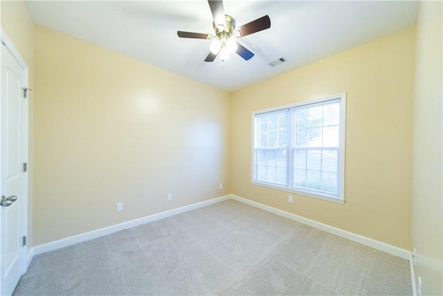 unfurnished room featuring ceiling fan and light colored carpet