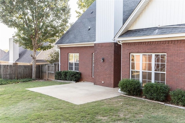 back of house featuring a yard and a patio