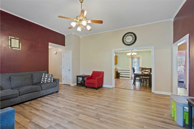 1417 Ridge Rd, Opelika, AL 36801 - living area featuring a chandelier, light wood-style flooring, a ceiling fan, and ornamental molding