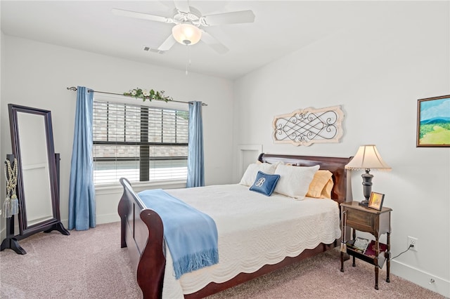 bedroom featuring light colored carpet, ceiling fan, visible vents, and baseboards