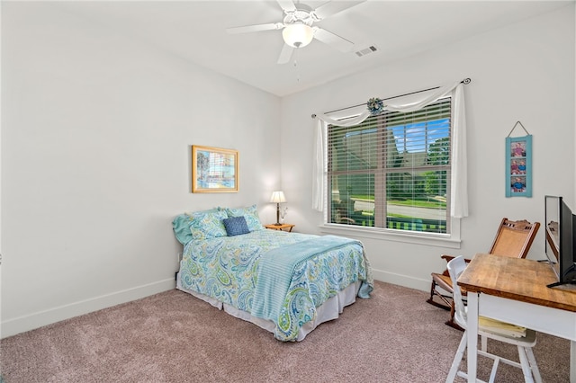 carpeted bedroom with visible vents, baseboards, and a ceiling fan