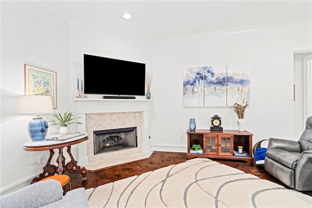 living room with baseboards, a fireplace, and crown molding