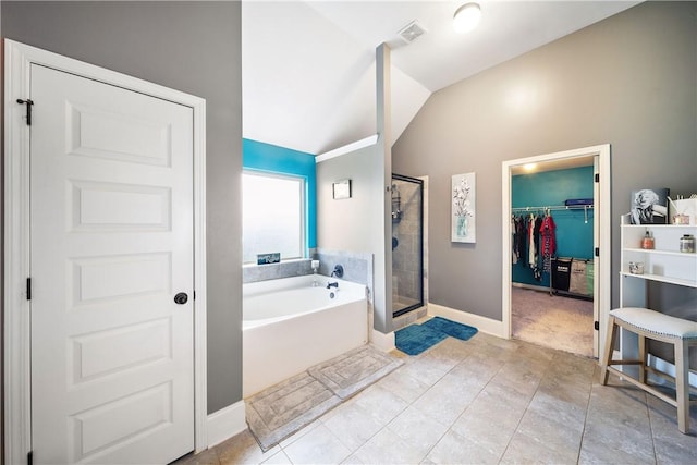 300 Holland Loop, Smiths Station, AL 36877 - full bath featuring vaulted ceiling, a garden tub, a walk in closet, a shower stall, and tile patterned floors