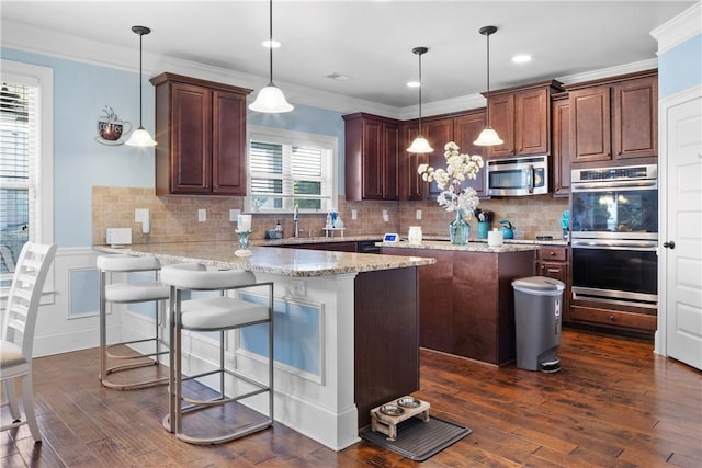 300 Holland Loop, Smiths Station, AL 36877 - kitchen with a peninsula, appliances with stainless steel finishes, dark wood-type flooring, decorative backsplash, and light stone countertops