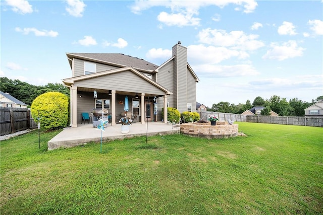 300 Holland Loop, Smiths Station, AL 36877 - back of property with a patio, a chimney, and a fenced backyard