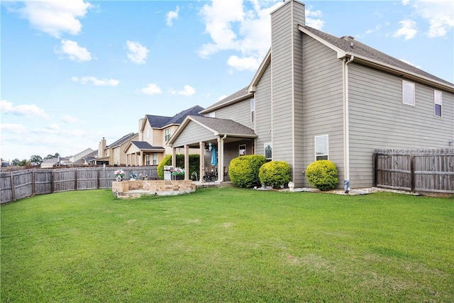 300 Holland Loop, Smiths Station, AL 36877 - rear view of house featuring a fenced backyard, a chimney, and a patio area