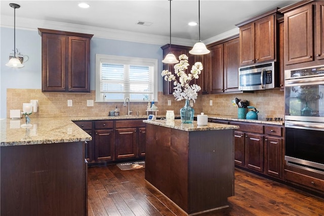 300 Holland Loop, Smiths Station, AL 36877 - kitchen featuring stainless steel appliances, light stone counters, dark wood-type flooring, decorative backsplash, and a kitchen island