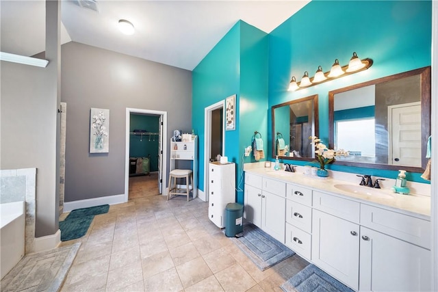 300 Holland Loop, Smiths Station, AL 36877 - full bath with high vaulted ceiling, double vanity, a garden tub, a shower, and a spacious closet