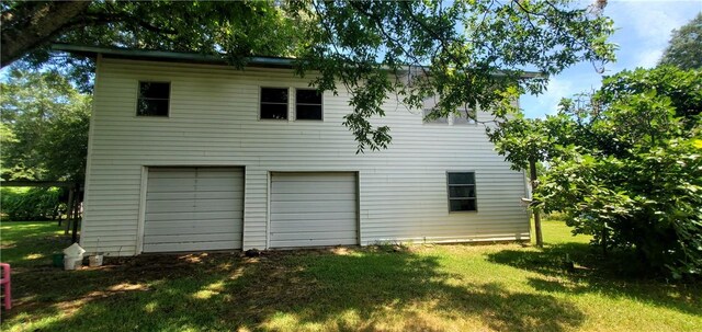 exterior space with a garage and a yard