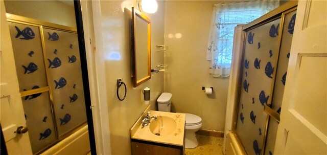 full bathroom featuring combined bath / shower with glass door, toilet, and vanity