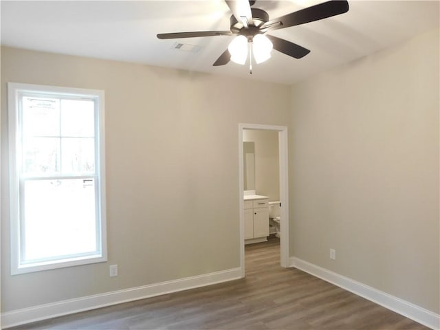 spare room featuring wood-type flooring and ceiling fan