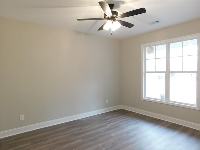 spare room with ceiling fan and dark wood-type flooring