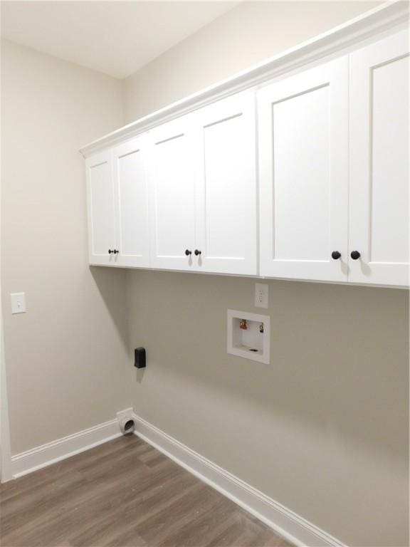 laundry area featuring cabinets, hookup for a washing machine, and hardwood / wood-style floors