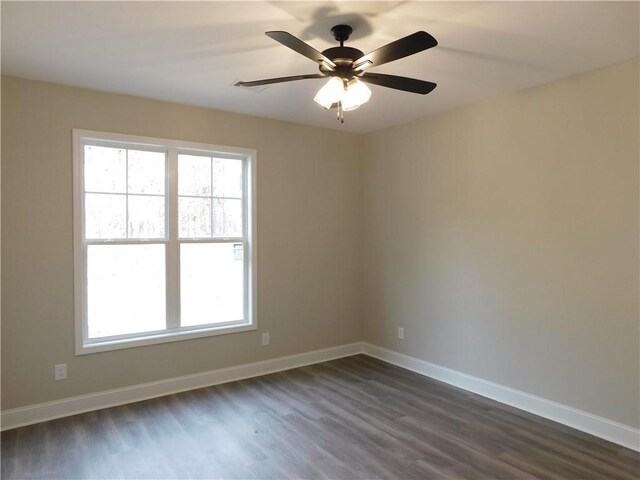 unfurnished room with ceiling fan and dark wood-type flooring