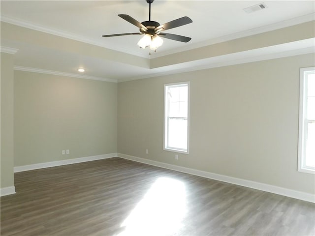 spare room with dark hardwood / wood-style flooring, ceiling fan, and ornamental molding