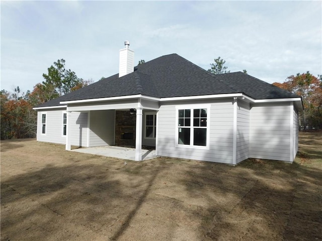 back of house featuring a patio area and a yard