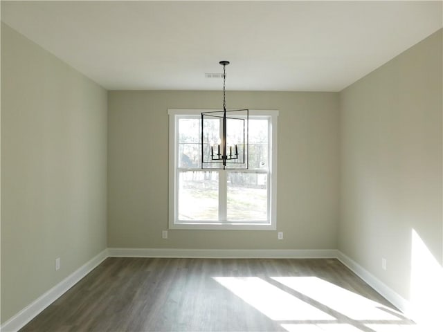 unfurnished dining area featuring dark hardwood / wood-style flooring and a notable chandelier