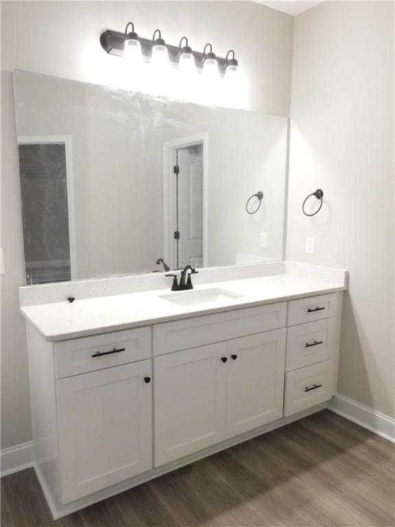 bathroom with hardwood / wood-style floors and vanity