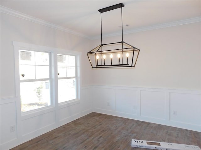 unfurnished dining area featuring dark wood-type flooring, a wealth of natural light, and ornamental molding