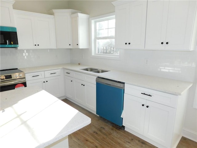 kitchen featuring dishwashing machine, white cabinets, and stainless steel range with electric stovetop