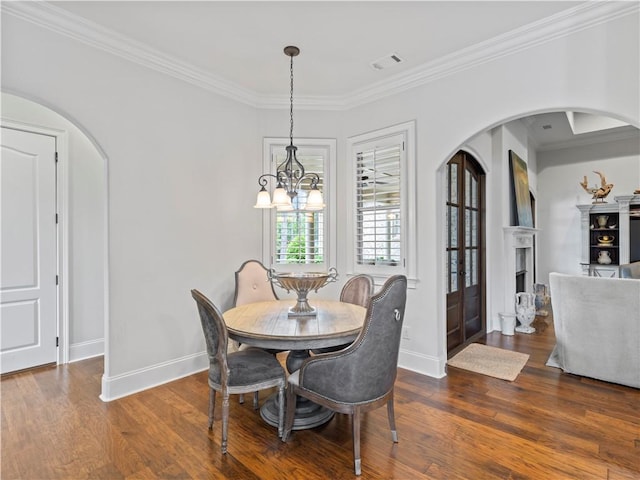 1655 Alex Ave, Auburn, AL 36030 - dining area featuring arched walkways, ornamental molding, baseboards, wood finished floors, and a chandelier