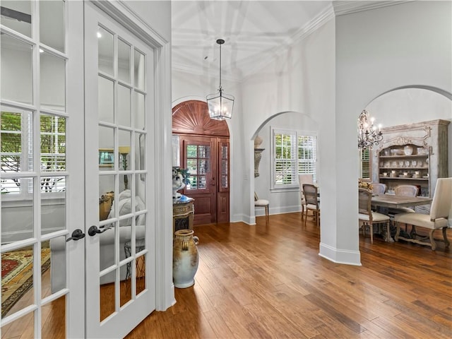 1655 Alex Ave, Auburn, AL 36030 - foyer with a chandelier, crown molding, french doors, arched walkways, and hardwood / wood-style floors