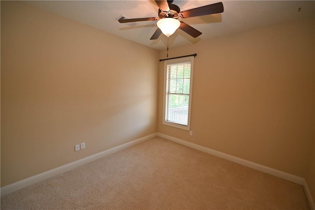 spare room with carpet floors and ceiling fan