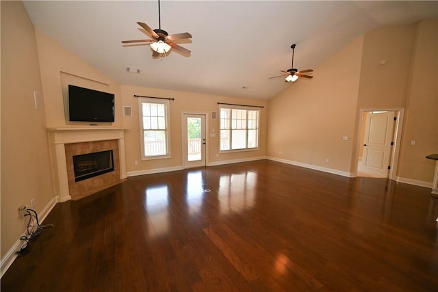 unfurnished living room with dark hardwood / wood-style flooring, ceiling fan, a fireplace, and lofted ceiling