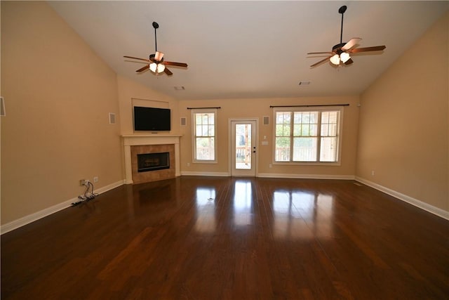 unfurnished living room featuring ceiling fan, a fireplace, dark wood-type flooring, and vaulted ceiling