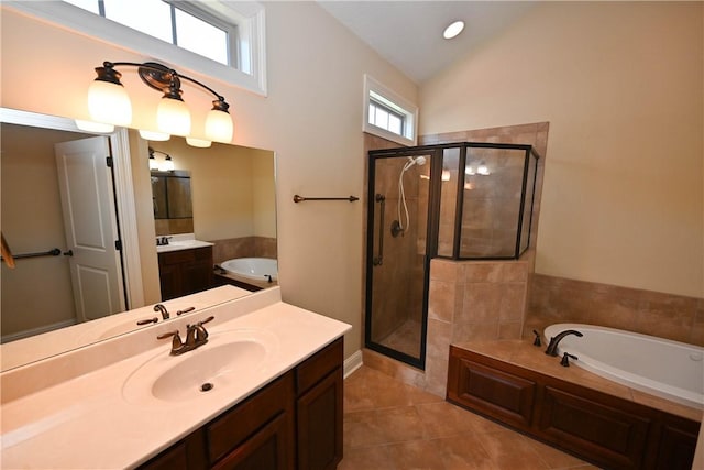 bathroom featuring shower with separate bathtub, vanity, tile patterned floors, and lofted ceiling