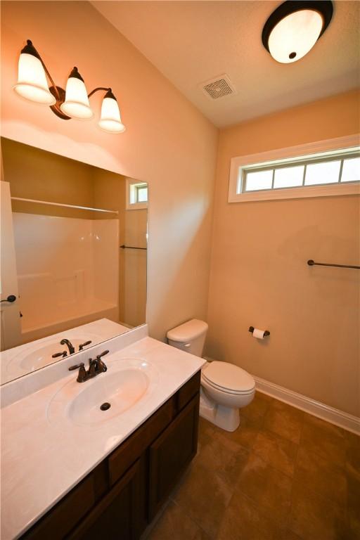 bathroom with vanity, toilet, and walk in shower