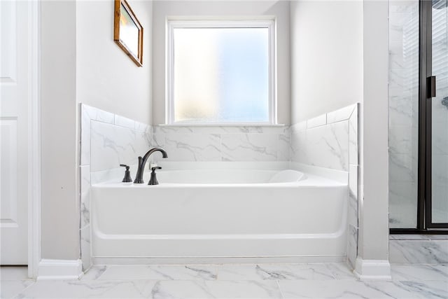 bathroom featuring a tub to relax in