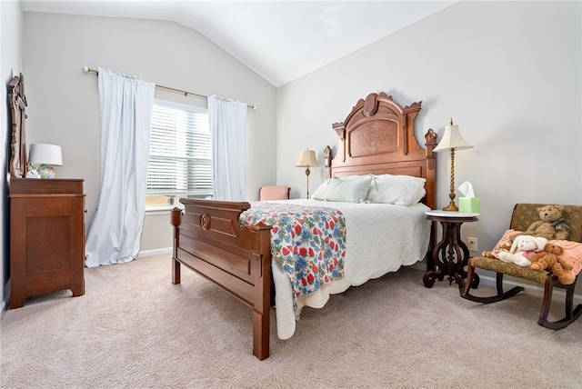 bedroom featuring light colored carpet and lofted ceiling