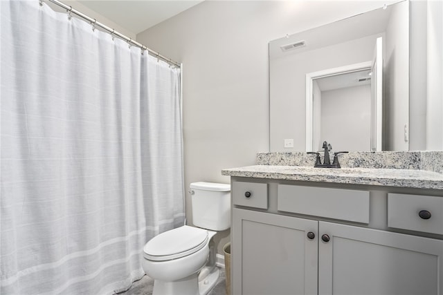 bathroom with toilet, vanity, and a shower with shower curtain