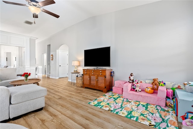 living room featuring light wood-type flooring, vaulted ceiling, and ceiling fan