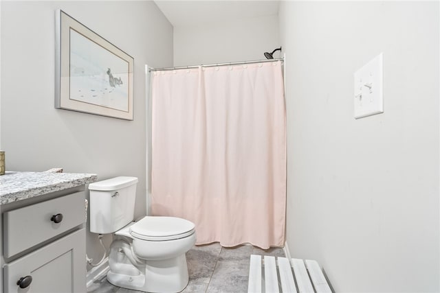 bathroom featuring toilet, vanity, and a shower with curtain