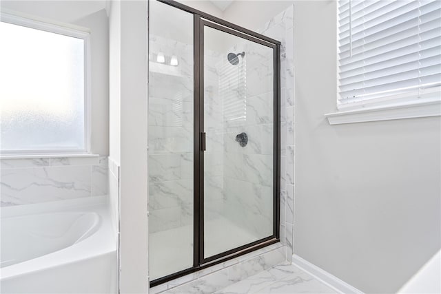 bathroom with independent shower and bath and a wealth of natural light