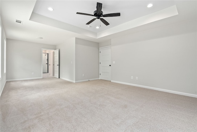 750 Mcdonald Dr, Opelika, AL 36801 - unfurnished bedroom with a tray ceiling, recessed lighting, light carpet, and a ceiling fan