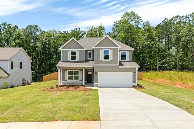 750 Mcdonald Dr, Opelika, AL 36801 - view of front facade featuring board and batten siding, concrete driveway, an attached garage, a shingled roof, and covered porch