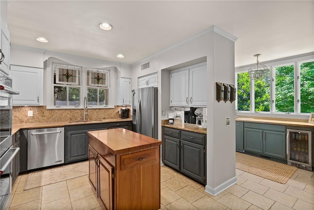 613 5th Ave, Opelika, AL 36801 - kitchen with stainless steel appliances, beverage cooler, a sink, wooden counters, and healthy amount of natural light