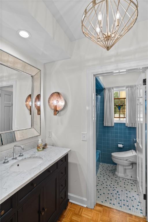 613 5th Ave, Opelika, AL 36801 - full bathroom featuring tile walls, toilet, vanity, and a chandelier