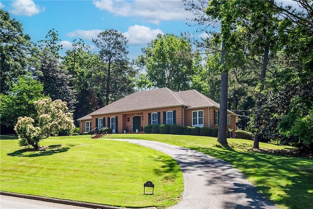 613 5th Ave, Opelika, AL 36801 - ranch-style house with a front lawn, asphalt driveway, and brick siding