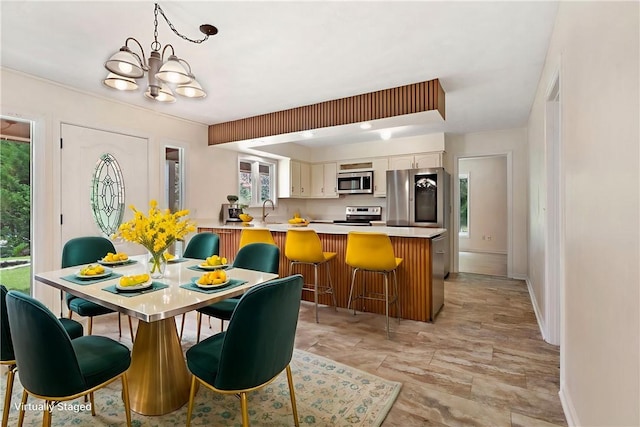 158 Alice Cir, Auburn, AL 36830 - dining space with a chandelier and baseboards