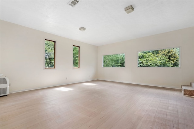 158 Alice Cir, Auburn, AL 36830 - spare room with stairs, light wood-style floors, and heating unit