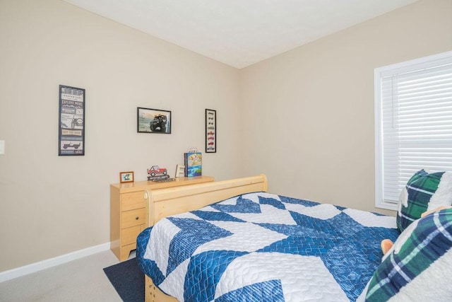 carpeted bedroom featuring baseboards