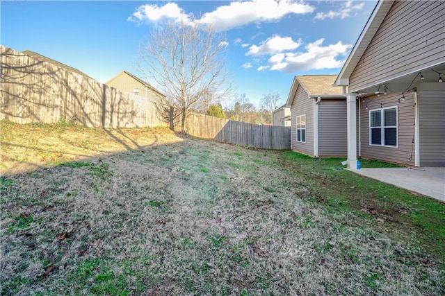 view of yard with a fenced backyard and a patio