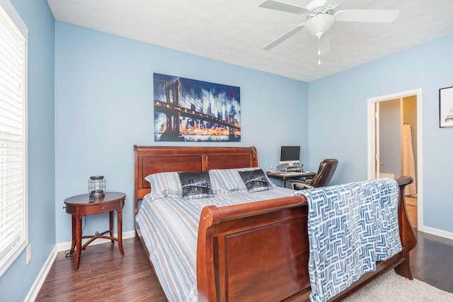 bedroom featuring ceiling fan, dark wood-type flooring, and baseboards