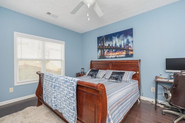 bedroom with dark wood-style floors, baseboards, visible vents, and a ceiling fan