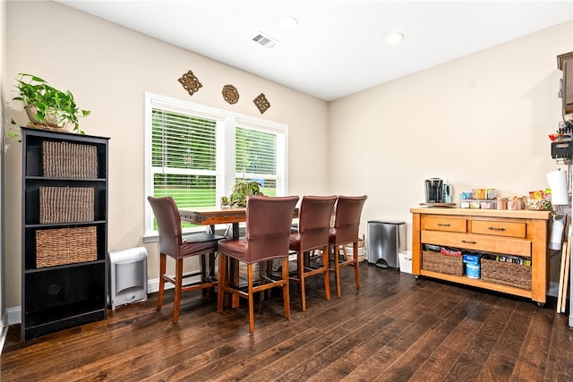 dining area with dark wood-style flooring and recessed lighting