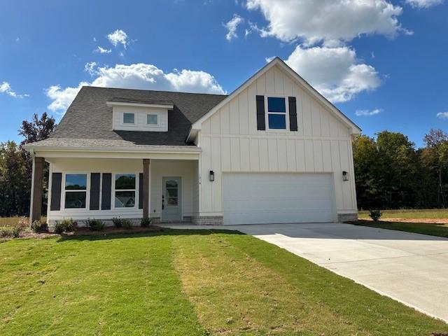 view of front of home with a front yard and a garage